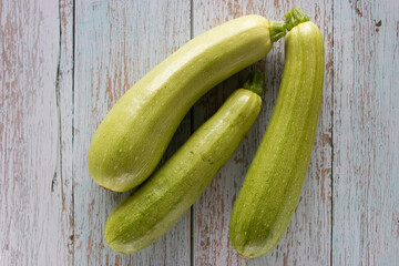 Organic zucchini on an old wooden background. Top view.