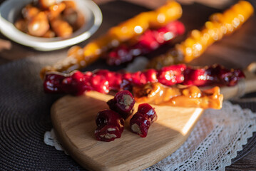 oriental sweet with nuts - churchkhela on a wood background