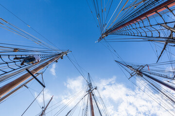 Fototapeta premium USA, Massachusetts, Cape Ann, Gloucester. Gloucester Schooner Festival, schooner masts at dawn.