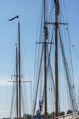 Fototapeta premium USA, Massachusetts, Cape Ann, Gloucester. Gloucester Schooner Festival, schooner masts at dawn.