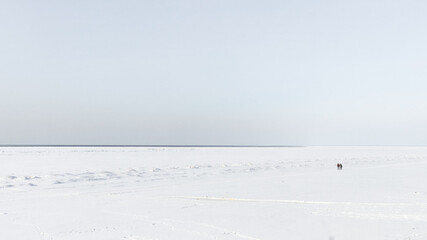 People on the background of the frozen sea