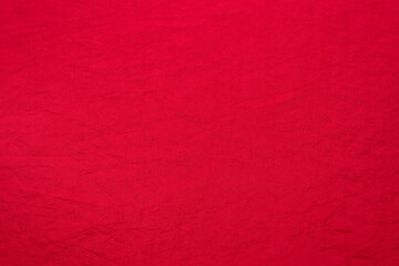 Fabric or canvas. A piece of crumpled fabric of dark red color. Material for sewing clothes