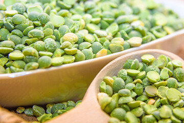 Green peas close up. Peas in a bowl with a spoon. Pea is a legume plant