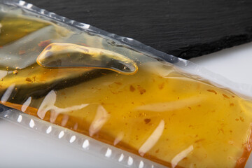 Olive oil in vacuum sealed plastic packaging on white background