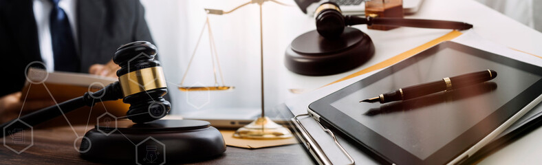 Business and lawyers discussing contract papers with brass scale on desk in office. Law, legal services, advice, justice and law concept picture with film grain effect