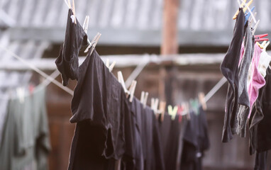 Colorful clothes and laundry hanging on a clothesline in country yard