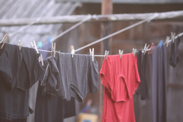 Colorful clothes and laundry hanging on a clothesline in country yard