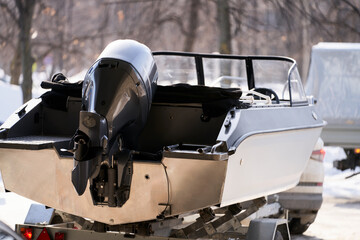  Transportation of a motor boat by passenger car using a trailer. Selective focus.