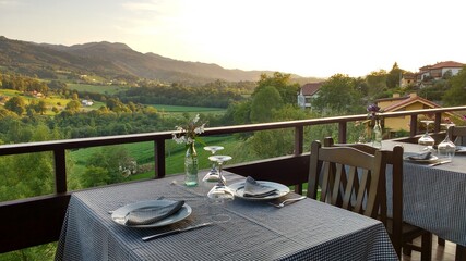 A table of a restaurant prepared to the dinner, Ceceda village, Asturias, Spain