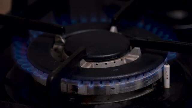 The process of ignition, combustion and extinguishing of a gas kitchen burner in slow motion. Gas burner close up.