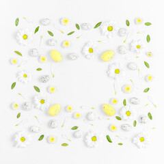 Creative layout composition of flowers and easter eggs on pastel background.