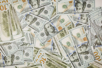 a lot of one hundred dollar bills on a white background for business