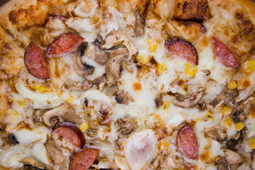 pizza with sausages and mushrooms close-up cheese