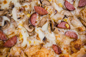 pizza with sausages and mushrooms close-up cheese