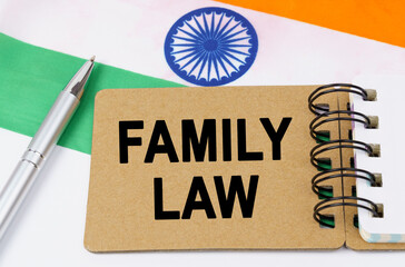 Against the background of the flag of India lies a notebook with the inscription - FAMILY LAW