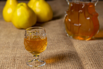 Homemade quince liqueur. Fresh quince.