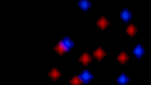 Abstract blurry, flashing light shapes bouncing on a black wall. Vivid, colourful disco light effects with different shapes, dots and forms are dancing on the wall
