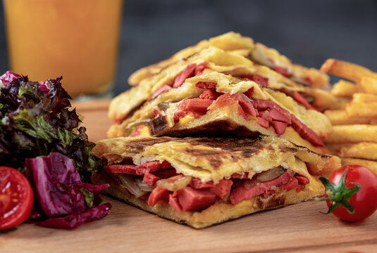 Turkish toast flat baked bread called bazlama with Turkish sausage and cheese on stone table, Bazlama Toast.