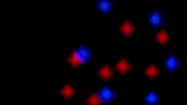 Abstract blurry, flashing light shapes bouncing on a black wall. Vivid, colourful disco light effects with different shapes, dots and forms are dancing on the wall