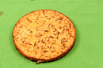 Whole cassava cake on green fabric background