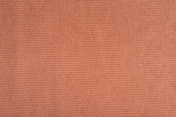 Photo of a Coral color cloth texture with come stripes.