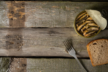 Sandwich with smoked sprats in oil on wooden table. top view - obrazy, fototapety, plakaty