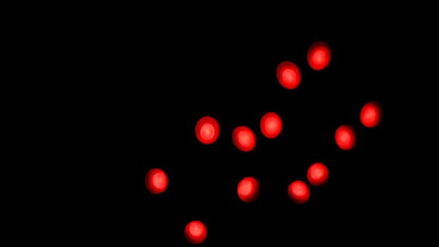 Abstract blurry, flashing light shapes bouncing on a black wall. Vivid, colourful disco light effects with different shapes, dots and forms are dancing on the wall