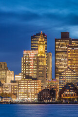 USA, Massachusetts, Boston. City skyline from Boston Harbor at dusk.