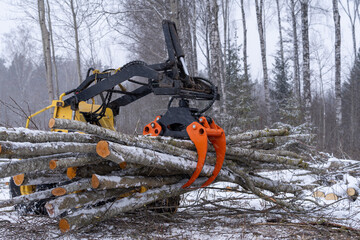 small stand-on mini skid steer with grapple full of wooden logs