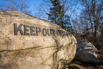 USA, Massachusetts, Cape Ann, Gloucester. Dogtown Rocks, inspirational saying carved on boulders in the 1920's, now in a pubic city park, 'Keep Out of Debt'.