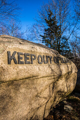 USA, Massachusetts, Cape Ann, Gloucester. Dogtown Rocks, inspirational saying carved on boulders in the 1920's, now in a pubic city park, 'Keep Out of Debt'.
