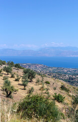 Fototapeta na wymiar View of the mountains, village and the sea from the cliff (Greece, Peloponnese)