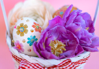 Fototapeta na wymiar white Easter eggs and flowers in basket on pink background, a minimal creative concept of a happy Easter