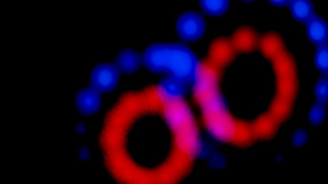 Abstract blurry, flashing light shapes bouncing on a black wall. Vivid, colourful disco light effects with different shapes, dots and forms are dancing on the wall