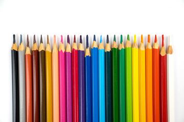 blunt colour pencils are arranged in the line on the white background and ready to paint.