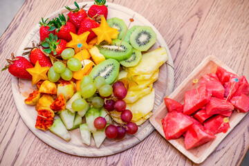 Raw Organic Fruit Platter With Berries, Melons, Kiwi, Mango, Pineapple, Carambola, Watermelon, Prickly Pear, Strawberry On The Wooden Board, On The Table, Top View, Selective Focus.
