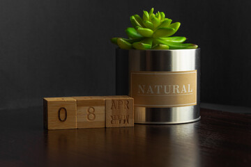 April 08. Image of the calendar April 08 wooden cubes  on a brown wooden table reflection and black background. with empty space for text