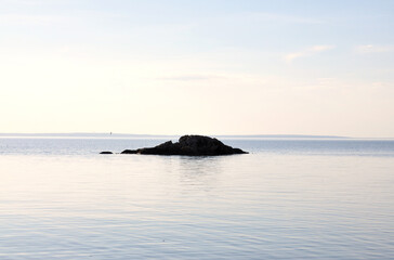 Fototapeta na wymiar Small island in calm water