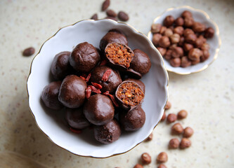 Chocolate home made energy balls. Healthy sweets. Home cooking. Vegetarian diet. Brown backgroung.