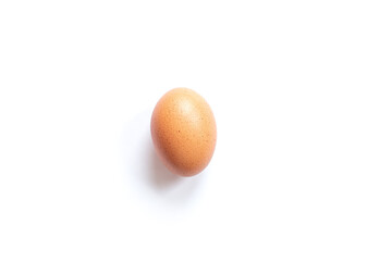 Single natural brown egg on white background, top view. Easter theme. Breakfast food. Boiled egg.