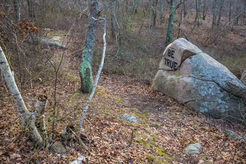 USA, Massachusetts, Cape Ann, Gloucester. Dogtown Rocks, inspirational saying carved on boulders in...