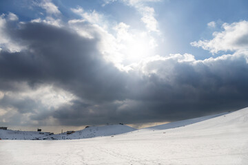 Mountains with snow in Campocatino (Italy) in winter. People walking and running in the background.