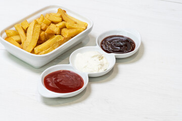 French fries with three dips, barbecue, mayo and ketchup