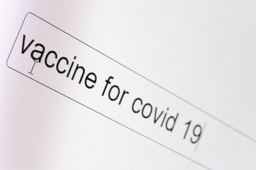 Search bar on a computer monitor with the question Vaccine for covid 19. Searching for information on the Internet, close up.