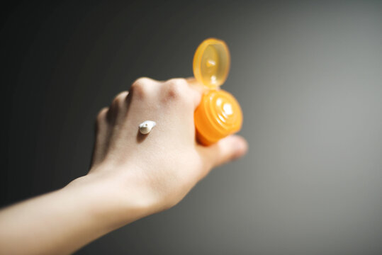 Woman Hand Applying Sunscreen Cream