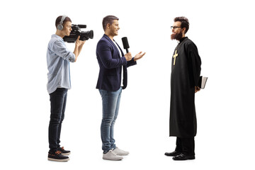 Reporter interviewing a catholic priest and a cameraman recording