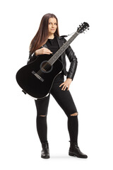 Young female musician with an acoustic guitar posing