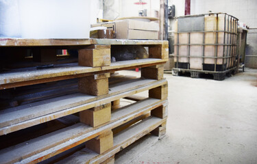 Wooden pallets stacked in a production area. Workshop for the production of paint.