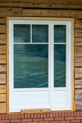 newly installed window in wooden cottage