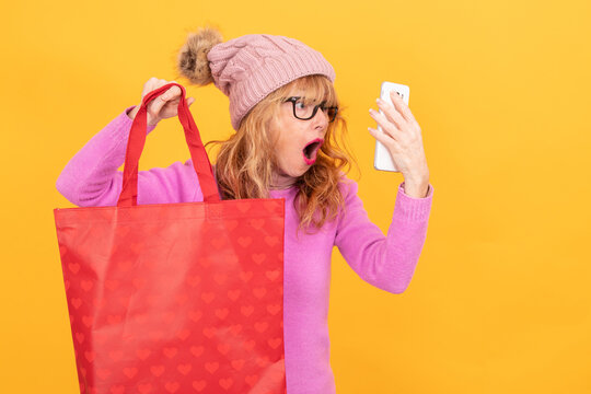 woman with bag and mobile phone isolated on background